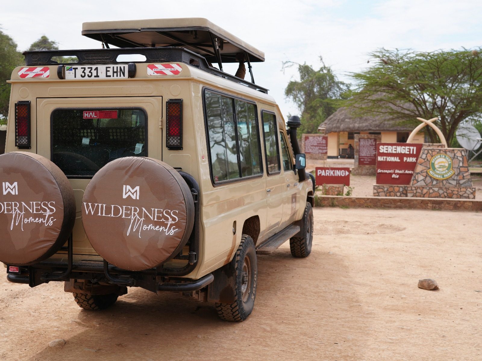 Wilderness Moments safari vehicle at the Serengeti National Park entrance gate